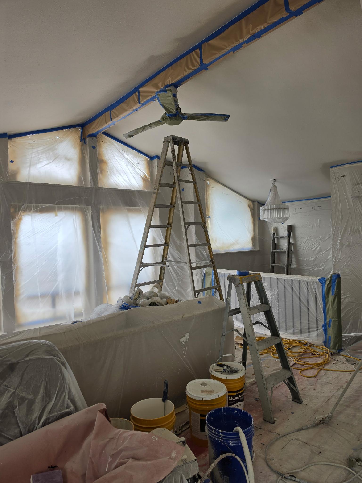 Vaulted ceiling room prepped for spray painting